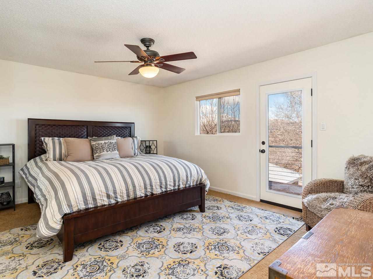 2075 Heatheridge Lane Reno, NV 89509 - Photo 15 of 25 a bedroom with a large bed and a window