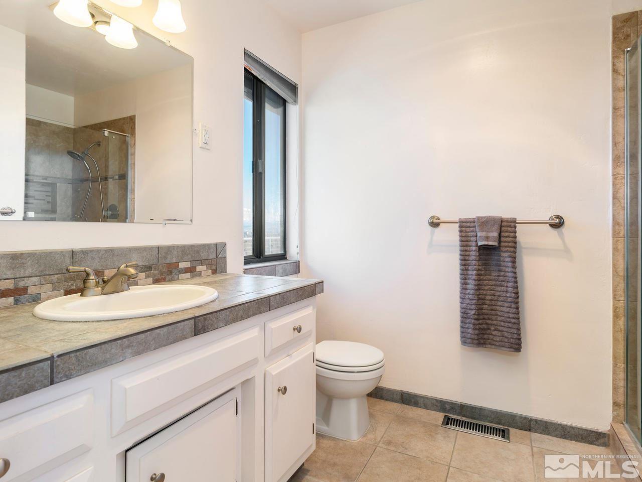 2075 Heatheridge Lane Reno, NV 89509 - Photo 16 of 25 a bathroom with a toilet sink and mirror