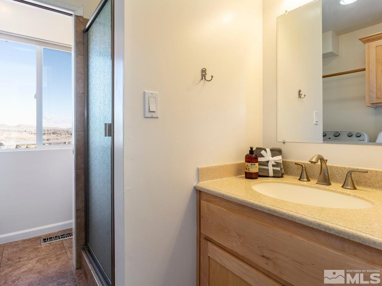 2075 Heatheridge Lane Reno, NV 89509 - Photo 18 of 25 a bathroom with a sink and a mirror