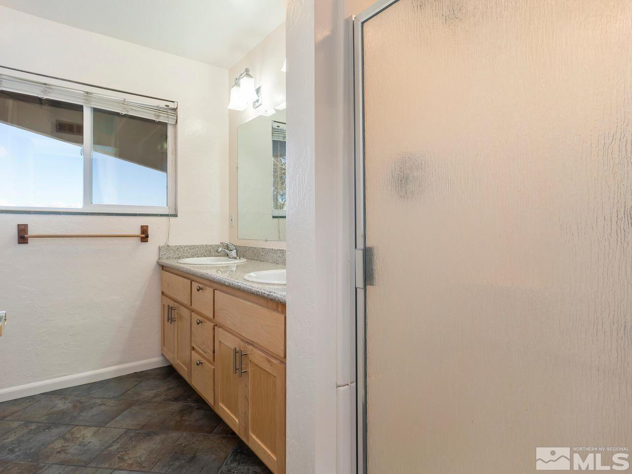 2075 Heatheridge Lane Reno, NV 89509 - Photo 22 of 25 a bathroom with a double vanity sink and mirror