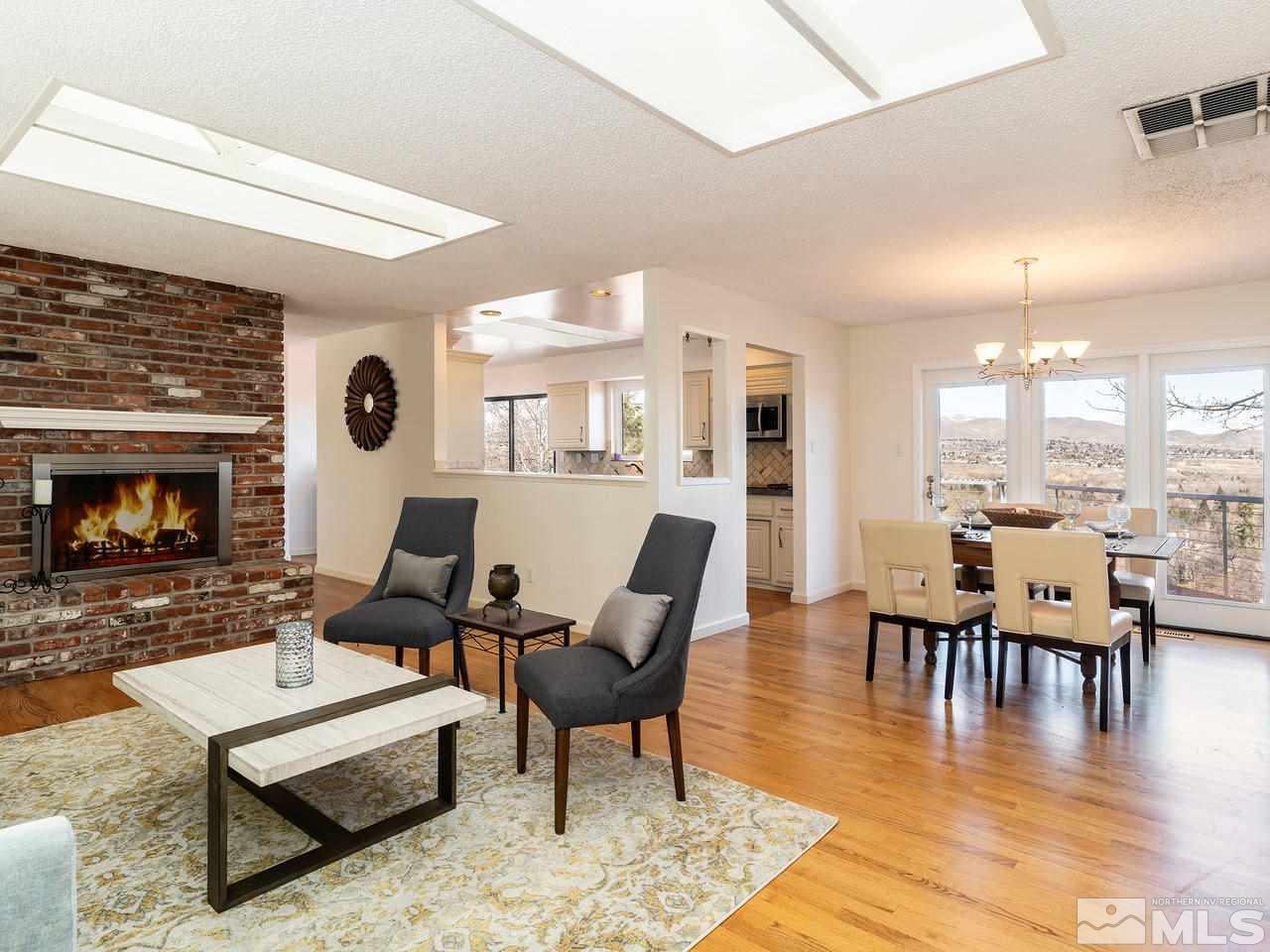 2075 Heatheridge Lane Reno, NV 89509 - Photo 9 of 25 a living room with furniture large window and a fireplace