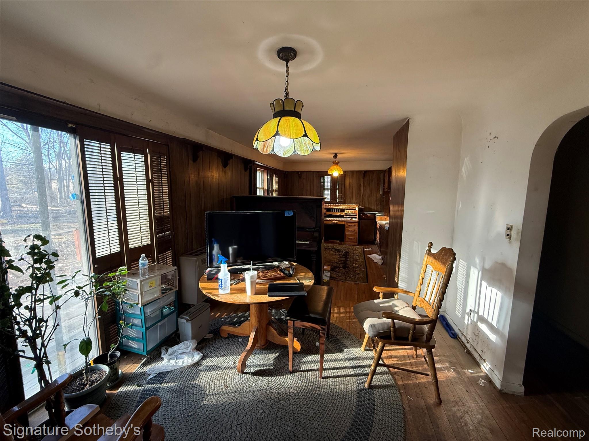 5825 North Lotz Road Canton, MI 48187 - Photo 4 of 10 Home office with arched walkways and dark wood-style flooring