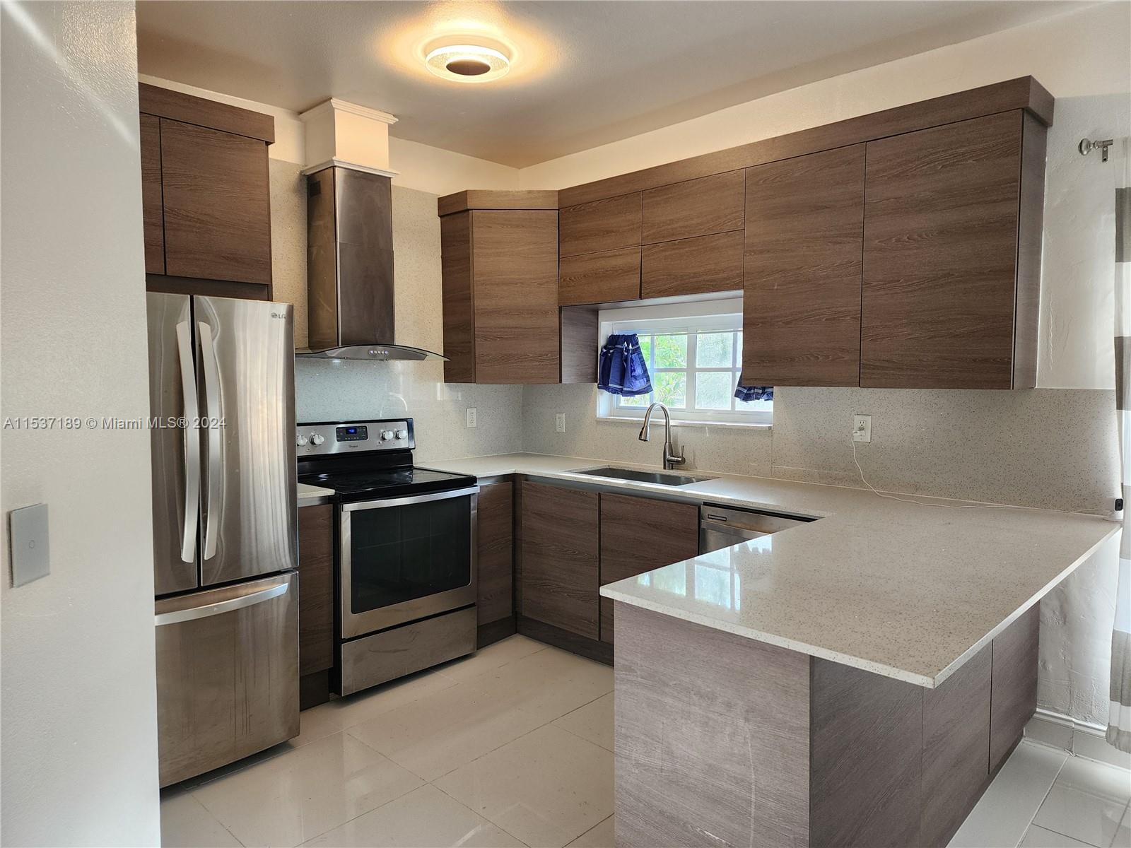 Buena Vista Miami, FL 33127 - Photo 6 of 19 a kitchen with stainless steel appliances a refrigerator sink and microwave