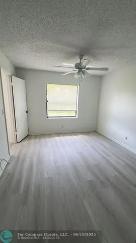 an empty room with windows and entrance