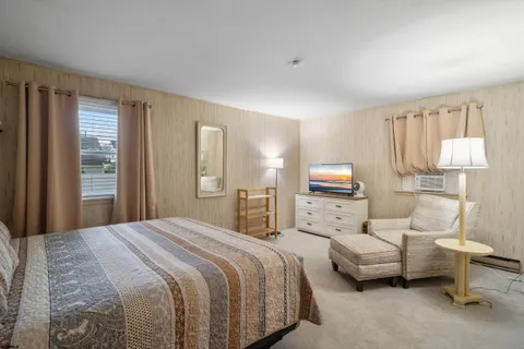 a bedroom with bed and a window