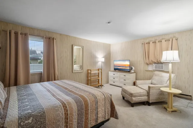 a bedroom with bed and a window