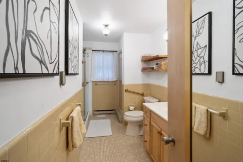 a bathroom with a toilet sink and mirror