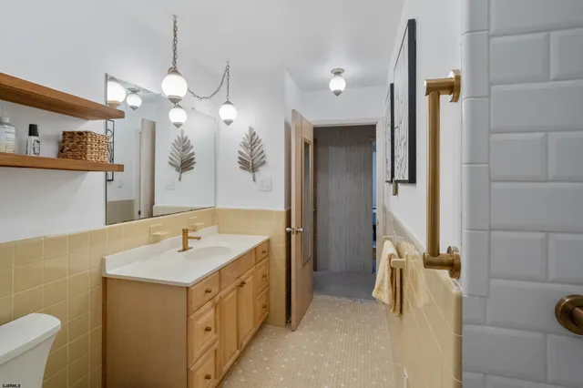 a bathroom with a sink a mirror and a shower