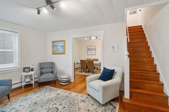 a living room with furniture and wooden floor