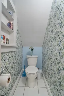a bathroom with a toilet and a shower curtain