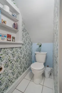 a bathroom with a toilet and a shower curtain