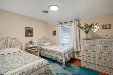 a bedroom with two beds and a window