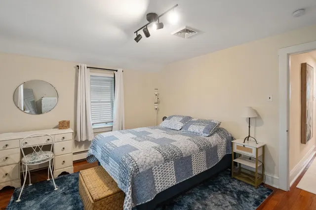 a bedroom with a bed and a mirror