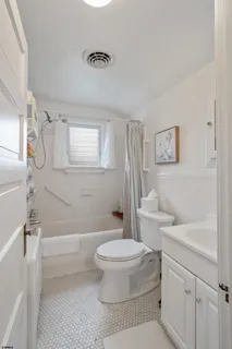 a bathroom with a toilet a sink and a bathtub