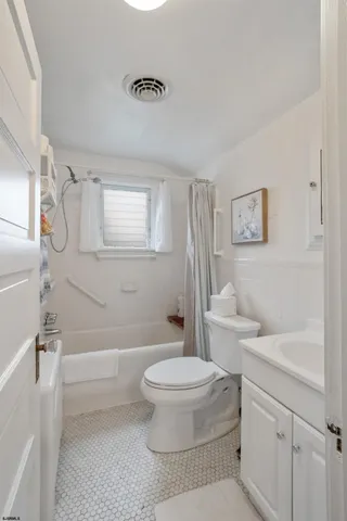 a bathroom with a toilet a sink and a bathtub