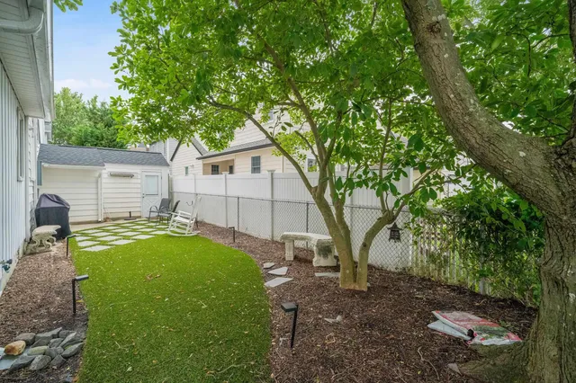 a view of backyard of house with seating space