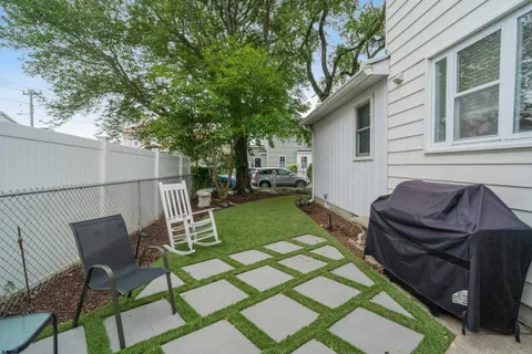 a backyard of a house with table and chairs