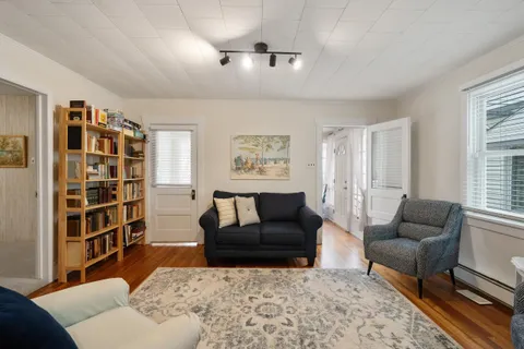 a living room with furniture and a book shelf