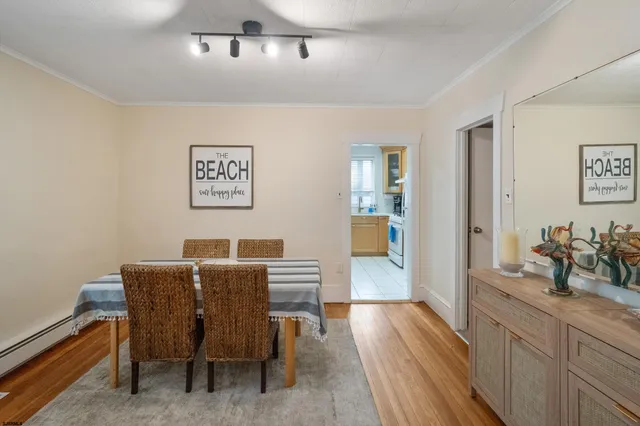 a view of a dining room with furniture and wooden floor