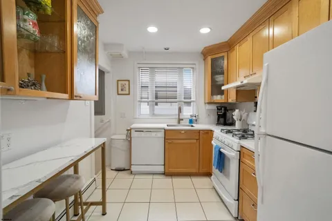 a kitchen with a sink a stove cabinets and counter space