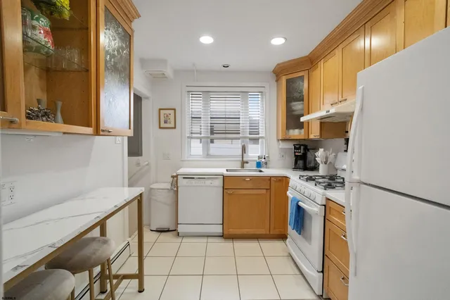 a kitchen with a sink a stove cabinets and counter space