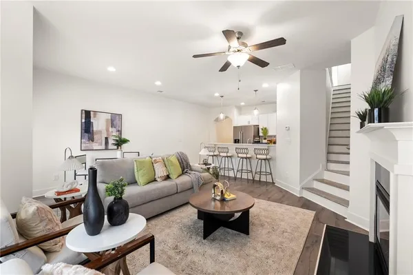 a living room with furniture and wooden floor