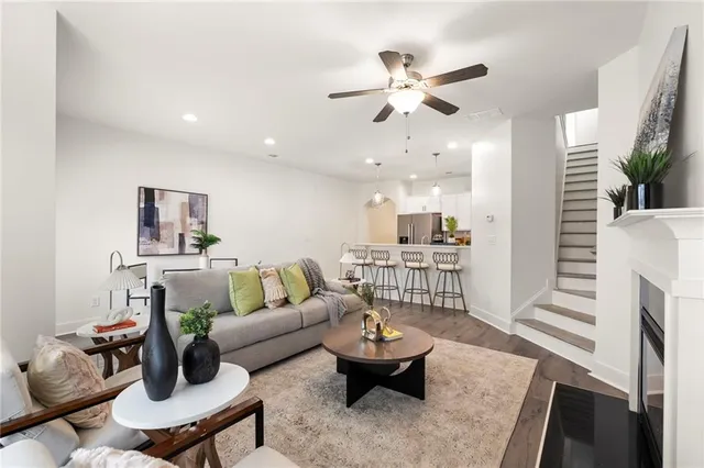 a living room with furniture and wooden floor