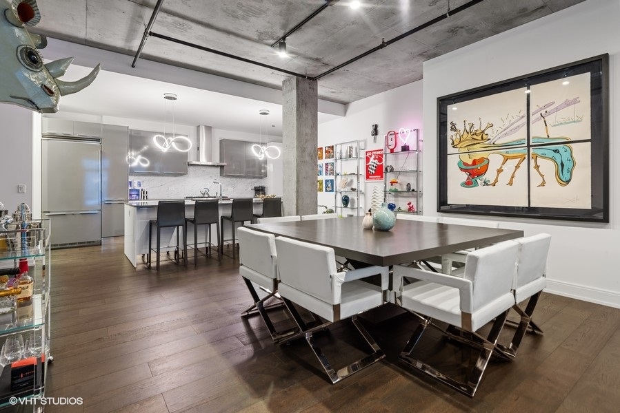 111 South Peoria Street, Unit 506 Chicago, IL 60607 - Photo 11 of 24 a dining room with wooden floor a glass table and chairs