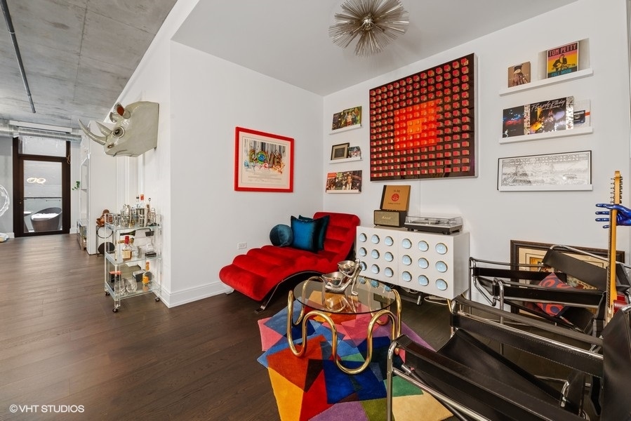 111 South Peoria Street, Unit 506 Chicago, IL 60607 - Photo 13 of 24 a bedroom with furniture and a book shelf
