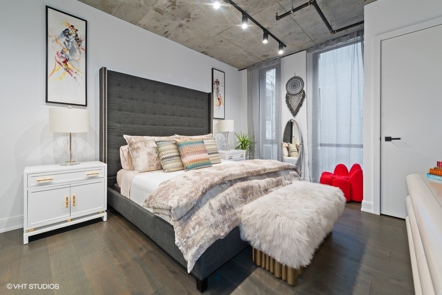 111 South Peoria Street, Unit 506 Chicago, IL 60607 - Photo 14 of 24 a bed room with a bed and a couch