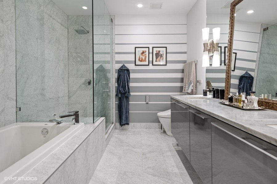 111 South Peoria Street, Unit 506 Chicago, IL 60607 - Photo 17 of 24 a spacious bathroom with a tub sink and mirror
