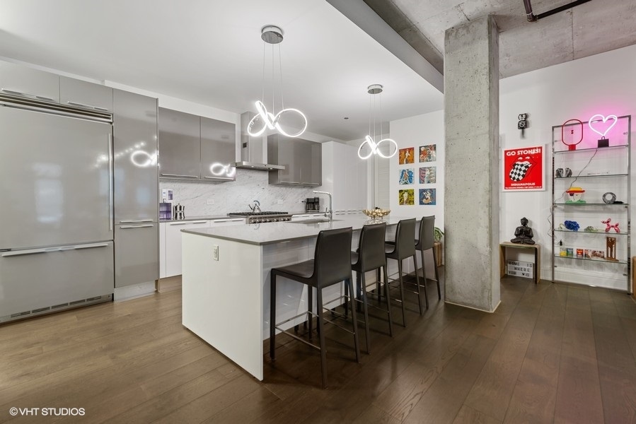 111 South Peoria Street, Unit 506 Chicago, IL 60607 - Photo 6 of 24 a kitchen with a refrigerator and countertop