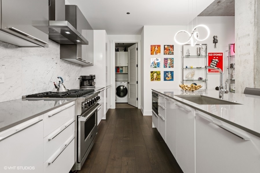 111 South Peoria Street, Unit 506 Chicago, IL 60607 - Photo 7 of 24 a kitchen with stainless steel appliances a sink stove and cabinets