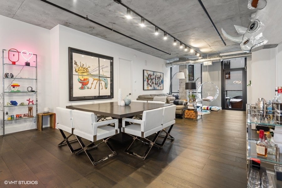 111 South Peoria Street, Unit 506 Chicago, IL 60607 - Photo 10 of 24 a living room with furniture and a chandelier