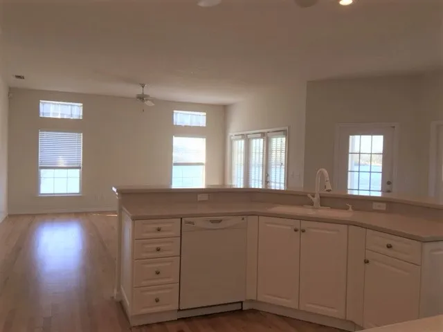 a kitchen with cabinets appliances and a window