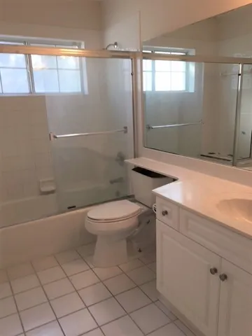 a bathroom with a toilet a sink and shower