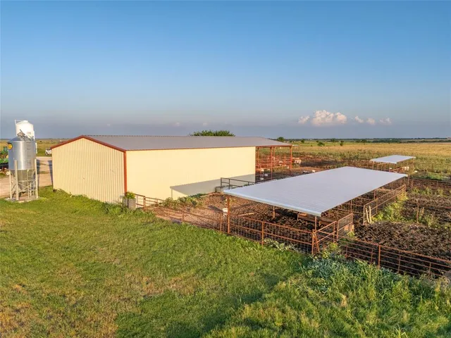 a front view of a house with yard and green space