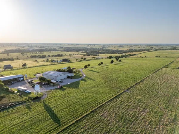 an aerial view of a residential houses with outdoor space