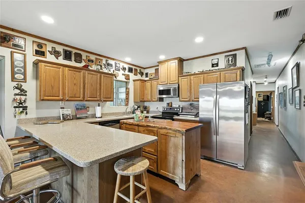a kitchen with a refrigerator a stove a sink and a refrigerator