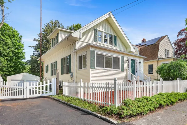 a front view of a house with a garden