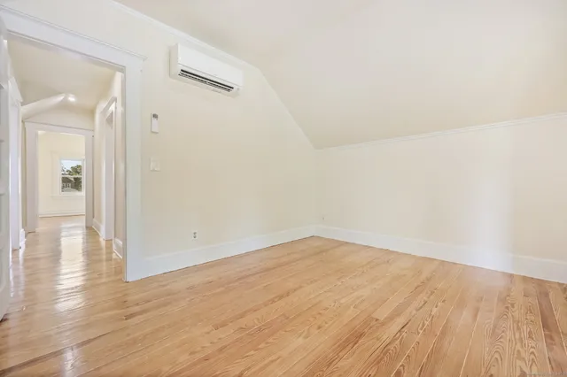 wooden floor in a hall with an empty room