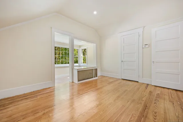 wooden floor in an empty room with a window