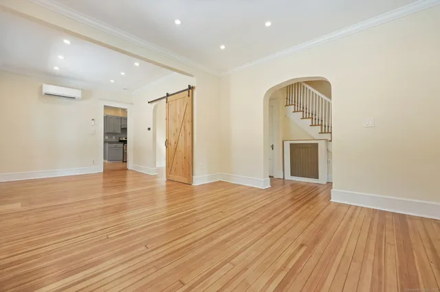 a view of empty room with wooden floor and fireplace
