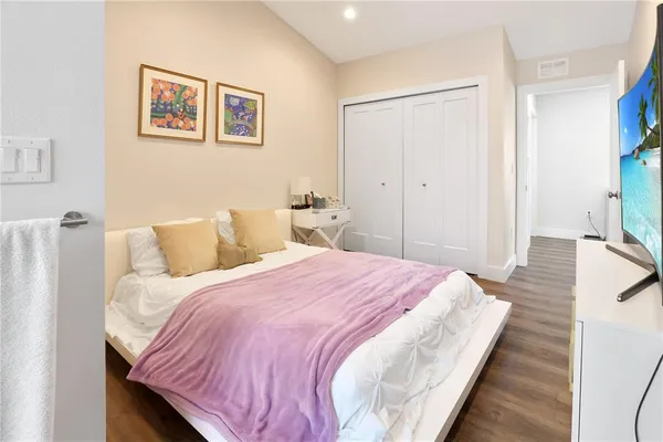 a bedroom with bed and cupboard
