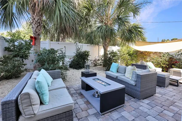 a view of a patio with couches and a potted plant