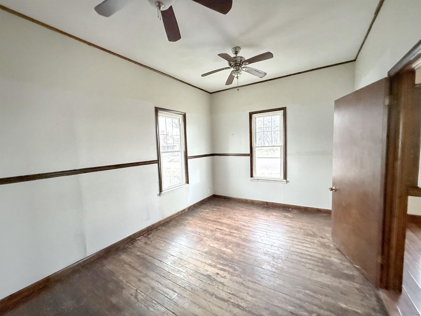 220 South 14th Street Murphysboro, IL 62966 - Photo 7 of 11 a view of an empty room with a window and wooden floor