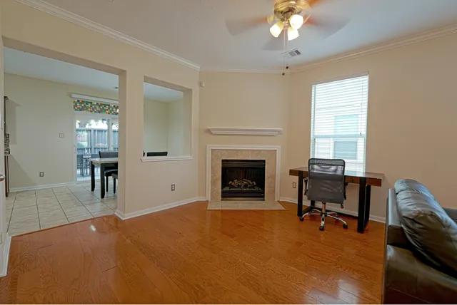 a view of a livingroom with a fireplace and workspace