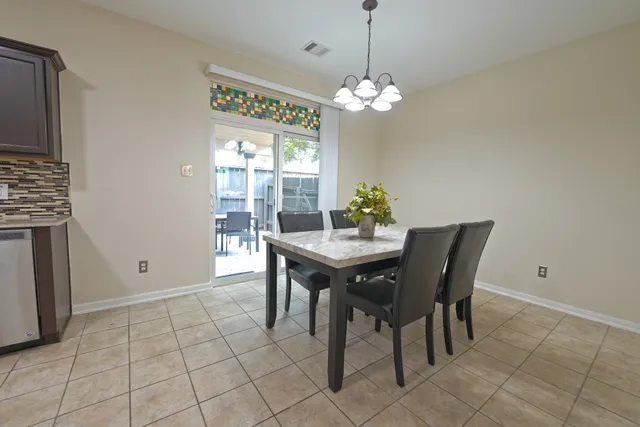 a view of a dining room with furniture and chandelier