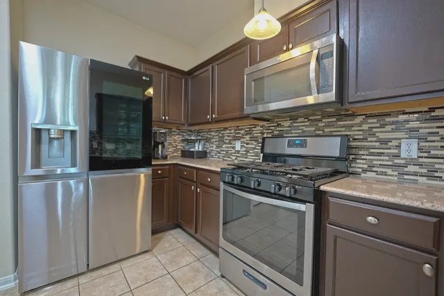 a kitchen with cabinets appliances and a sink