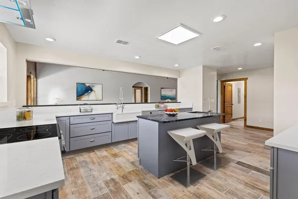 a kitchen with stainless steel appliances kitchen island granite countertop a sink and cabinets